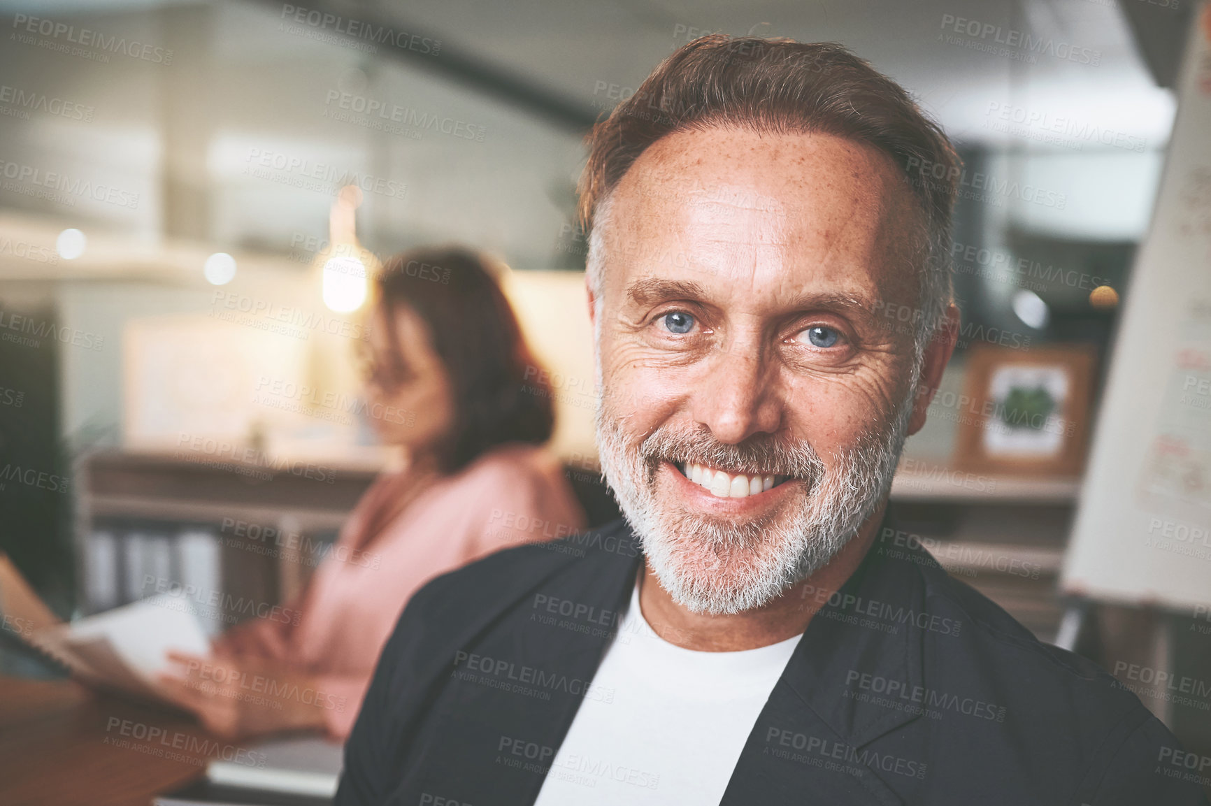 Buy stock photo Shot of a handsome mature businessman sitting in a meeting at the office