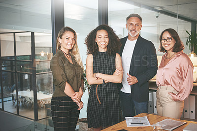Buy stock photo Shot of a diverse group of businesspeople standing together in the office during a meeting