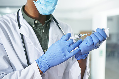 Buy stock photo Shot of a unrecognizable doctor holding a syringe in an office