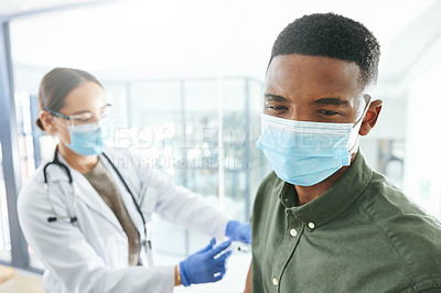 Buy stock photo Shot of a young doctor giving a patient an injection in an office