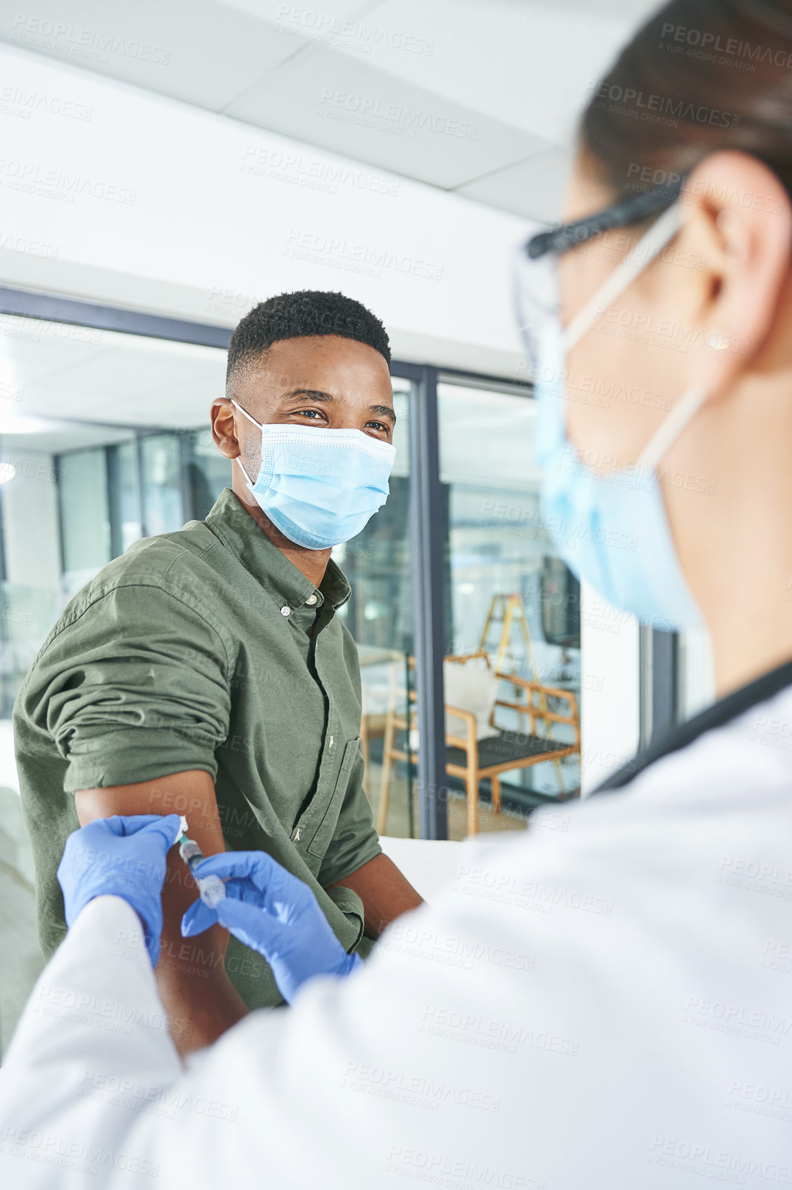 Buy stock photo Shot of an unrecognizable doctor giving a patient an injection in an office