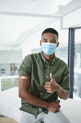 Buy stock photo Shot of a young man showing a thumbs up in a doctor's office