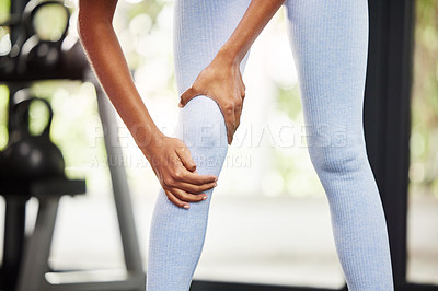 Buy stock photo Cropped shot of a woman suffering from a knee injury