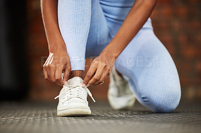 Buy stock photo Girl, tie laces and fitness in gym, getting ready and prepare for exercise or workout on floor. Female person, foot and fasten sneakers for sports training, running shoes and athlete for cardio