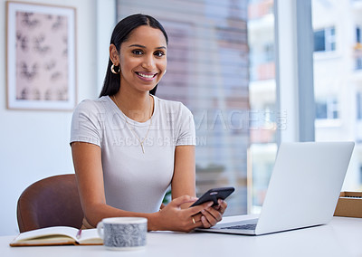 Buy stock photo Cropped portrait of an attractive young businesswoman sending a text while sitting at her desk in the office