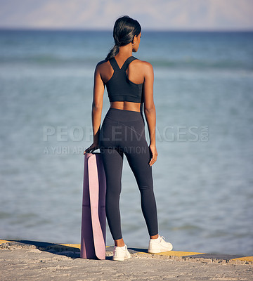 Buy stock photo Woman, fitness and peace with yoga mat at beach for outdoor workout, exercise or training in nature. Rear view of female person ready with equipment for balance in health and wellness by ocean coast