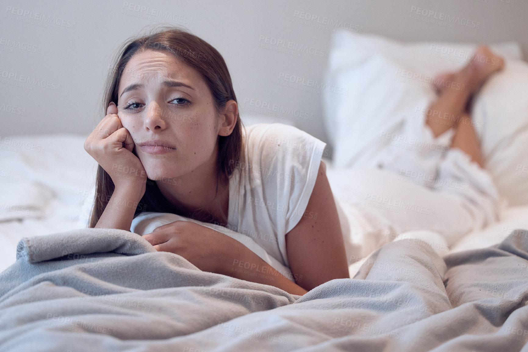 Buy stock photo Bored, depression and woman lying on bed for low energy, exhausted or insomnia in home. Fatigue, student and female person in bedroom for mental health, anxiety or stress from university in apartment