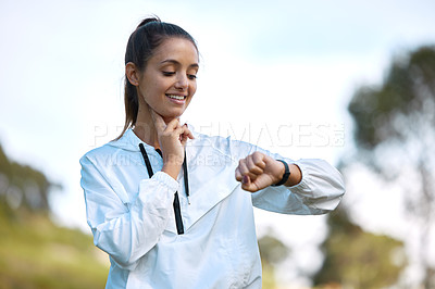 Buy stock photo Fitness, watch and heartbeat with a woman runner outdoor checking pulse during a cardio or endurance workout. Exercise, health and heart rate with a young athlete looking at the time while running