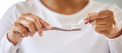 Buy stock photo Shot of a unrecognizable young woman brushing her teeth in the morning