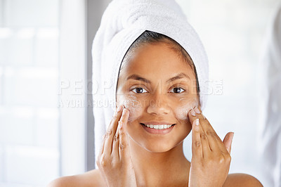 Buy stock photo Shot of young woman using with facial moisturiser