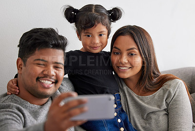 Buy stock photo Shot of parents taking a selfie with their daughter