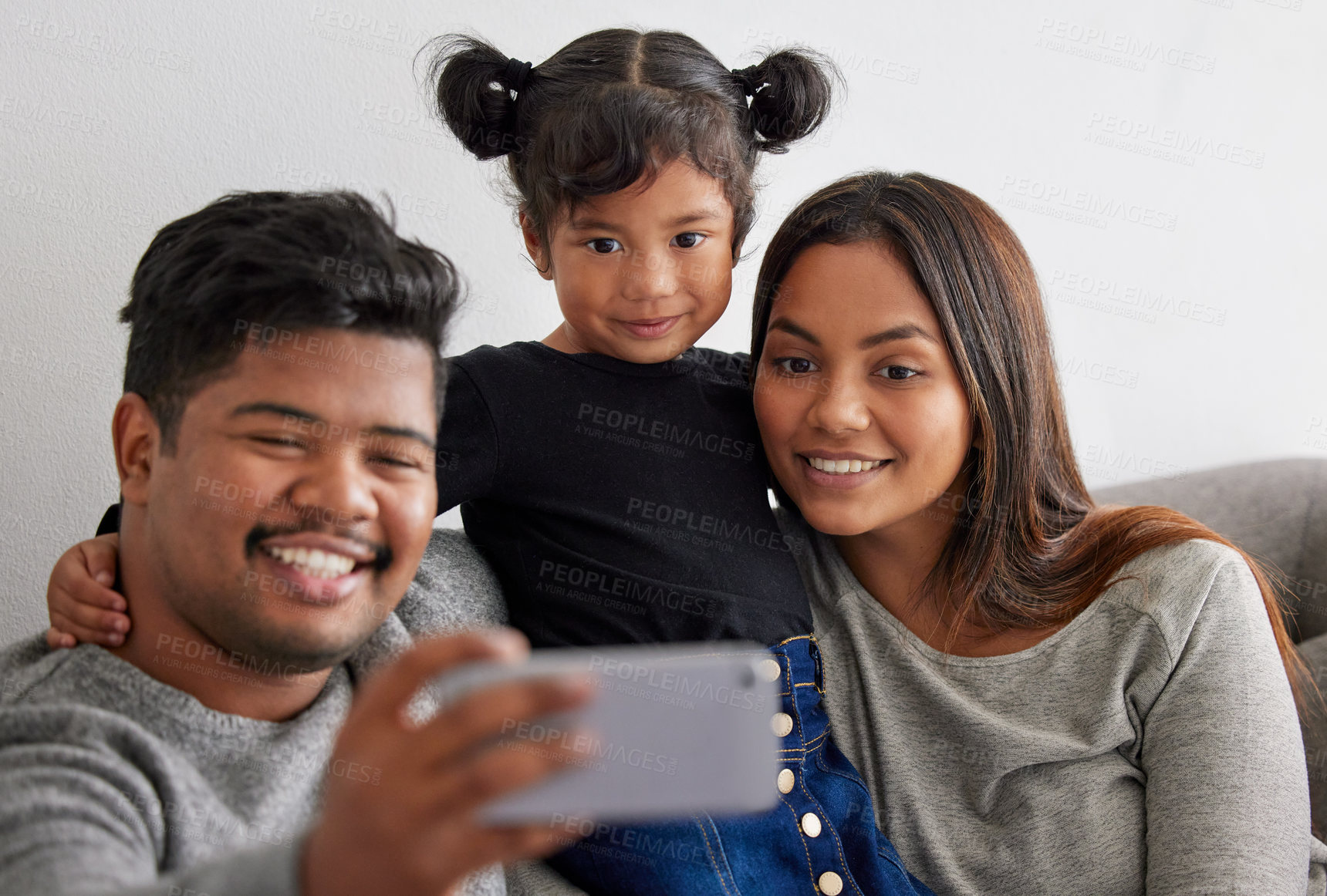 Buy stock photo Shot of parents taking a selfie with their daughter