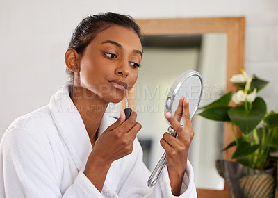 Buy stock photo Shot of a beautiful young woman going through her makeup routine at home