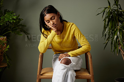Buy stock photo Shot of a young woman looking stressed shot against a studio background