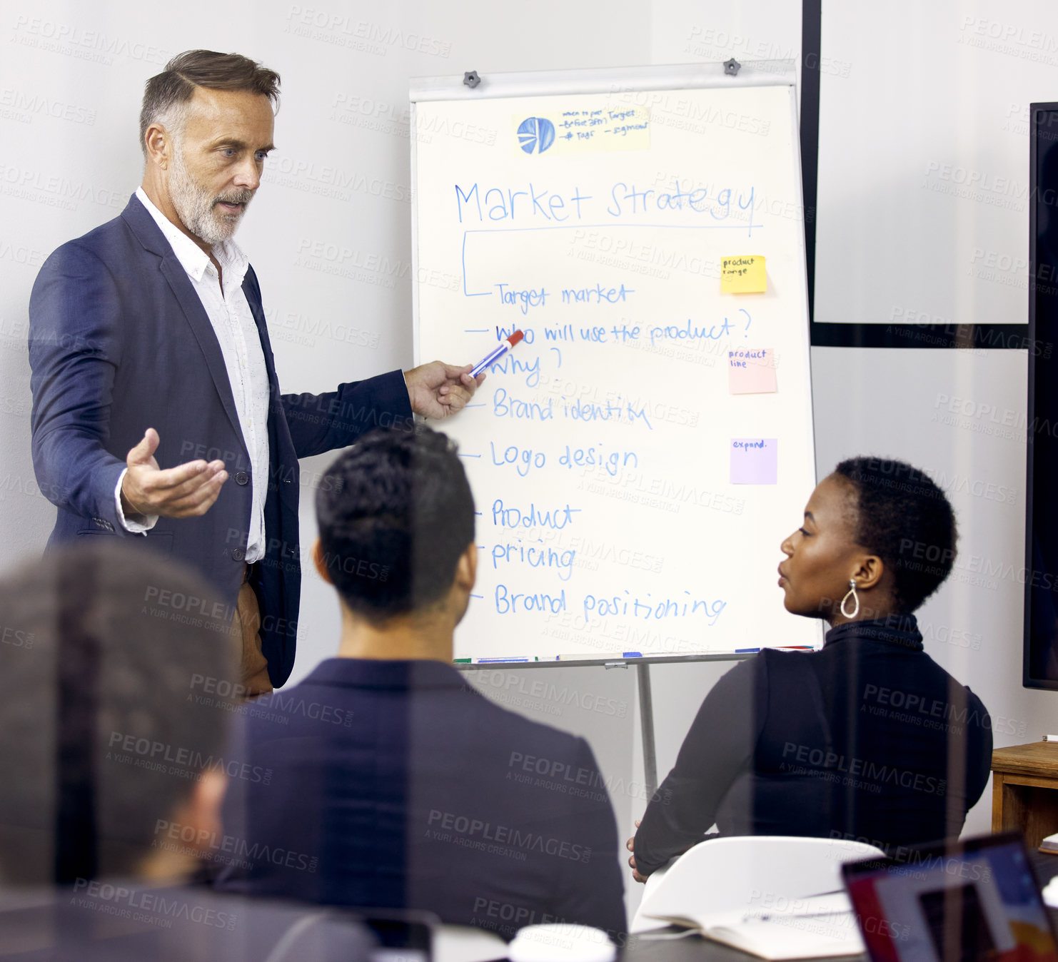 Buy stock photo Shot of a mature businessman giving a presentation in a boardroom at work