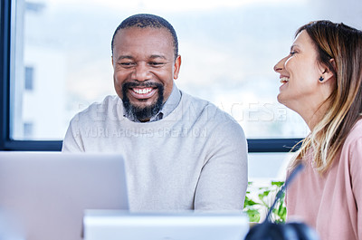 Buy stock photo Shot of two mature businesspeople working together in an office