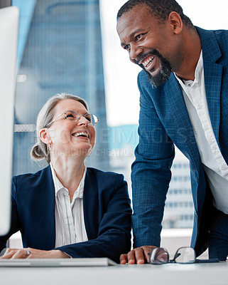 Buy stock photo Shot of two businesspeople having a discussion in the office while using a computer