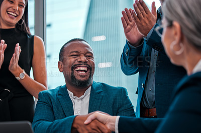 Buy stock photo Shot of coworkers shaking hands in a boardroom