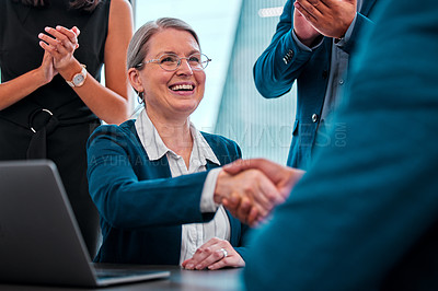 Buy stock photo Shot of coworkers applauding while their bosses shake hands