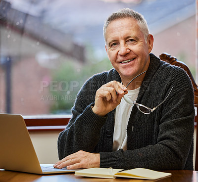 Buy stock photo Cropped portrait of a handsome senior man working on his laptop in the study