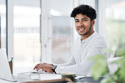 Buy stock photo Portrait of a young businessman working on a computer in an office