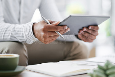 Buy stock photo Closeup shot of an unrecognisable businessman using a digital tablet in an office