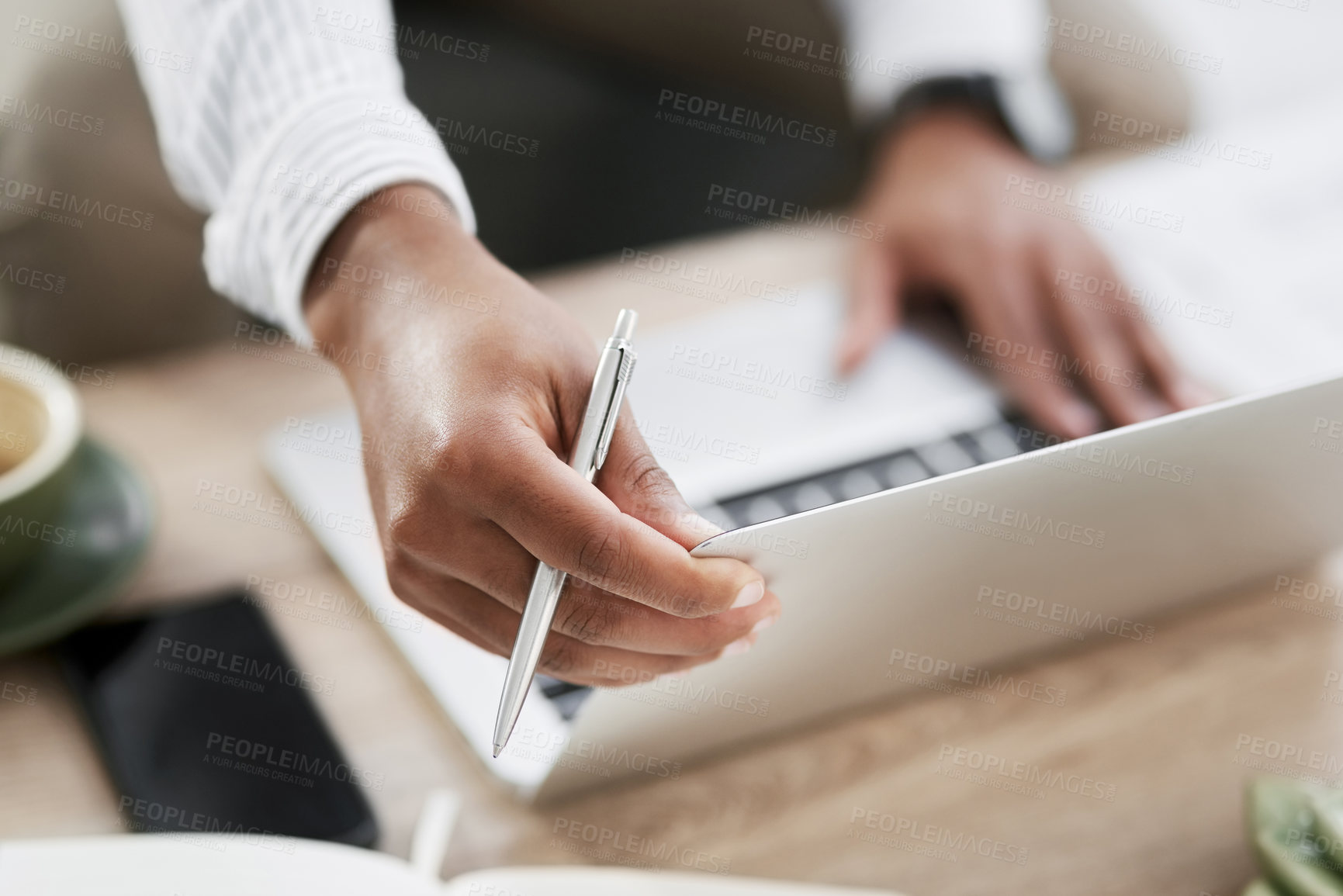 Buy stock photo Closeup shot of an unrecognisable businessman using a laptop in an office