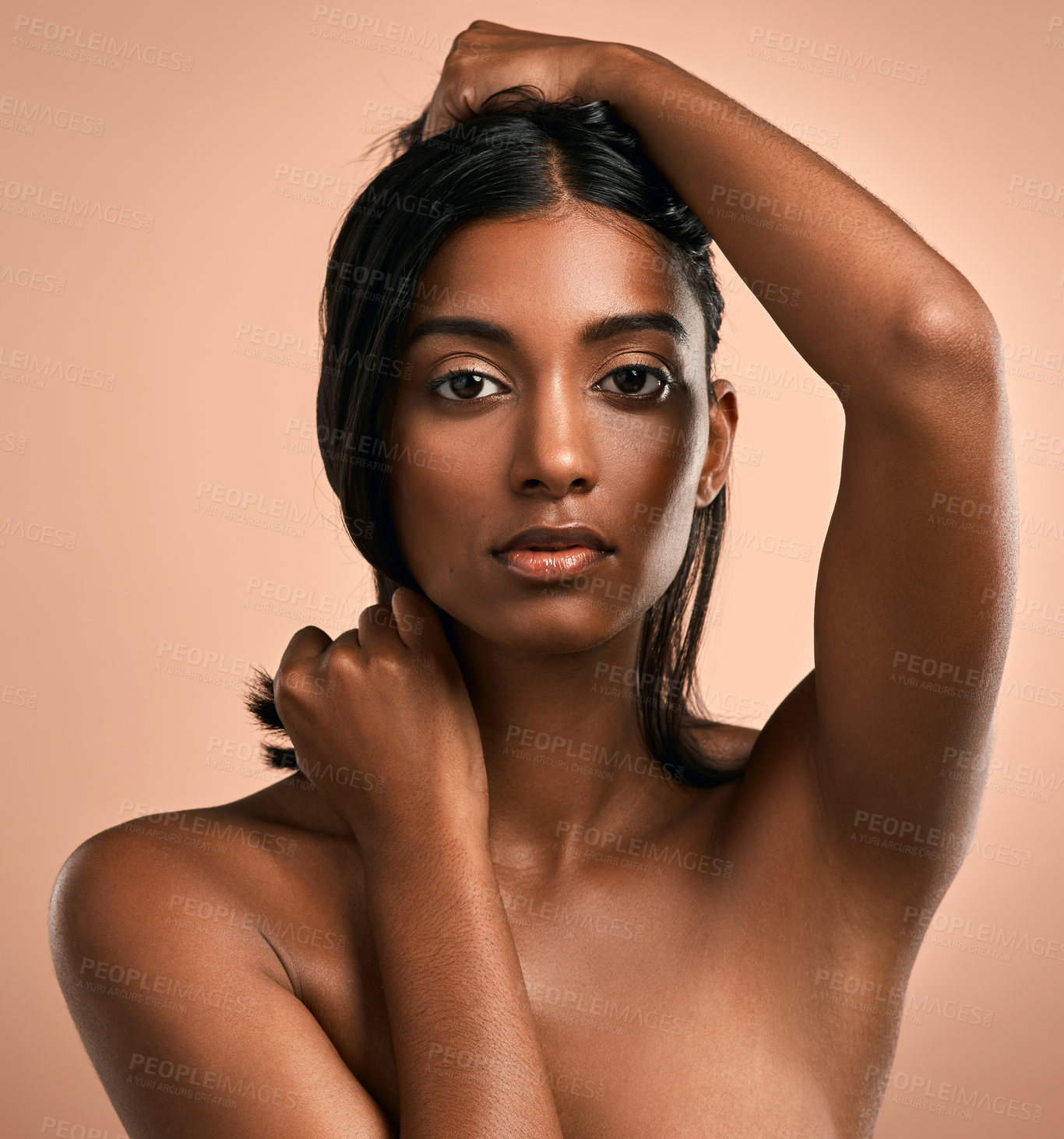 Buy stock photo Portrait of a beautiful young woman posing against a brown background