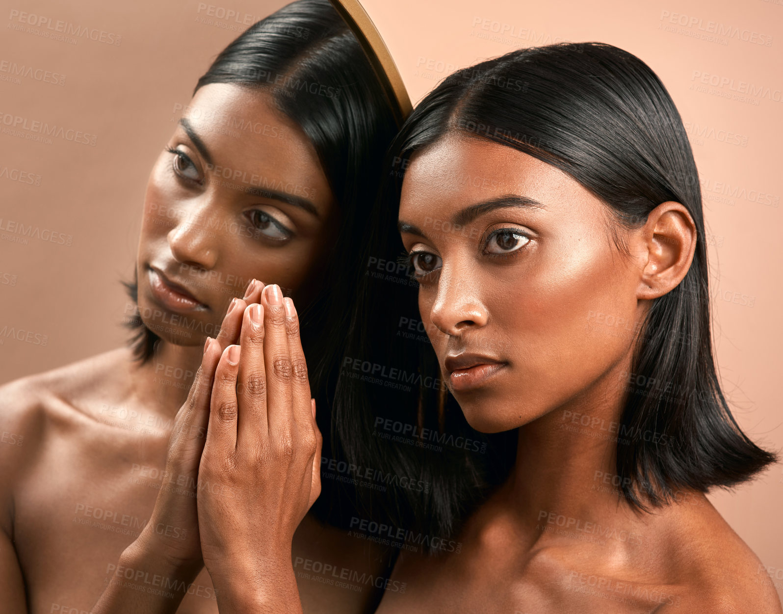 Buy stock photo Shot of a beautiful young woman touching a mirror and  posing against a brown background