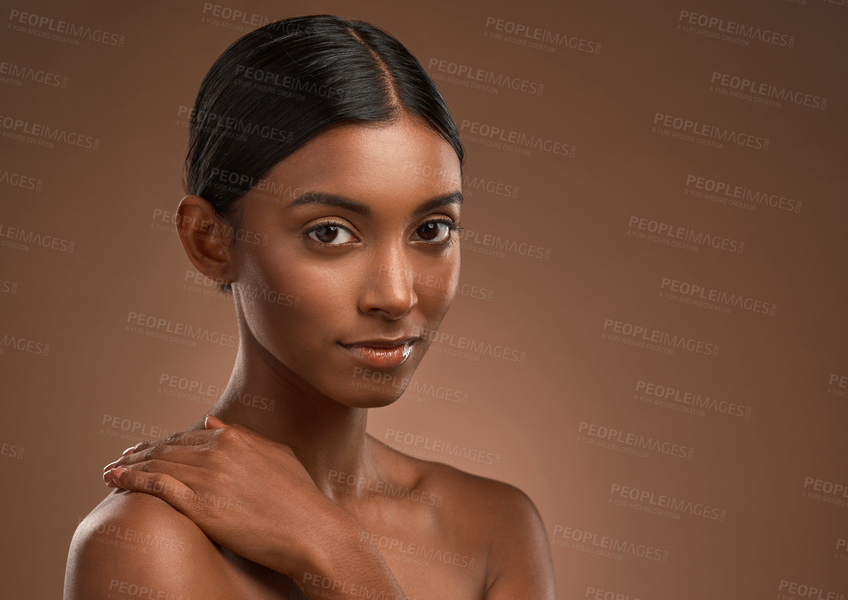 Buy stock photo Portrait of a beautiful young woman posing against a brown background