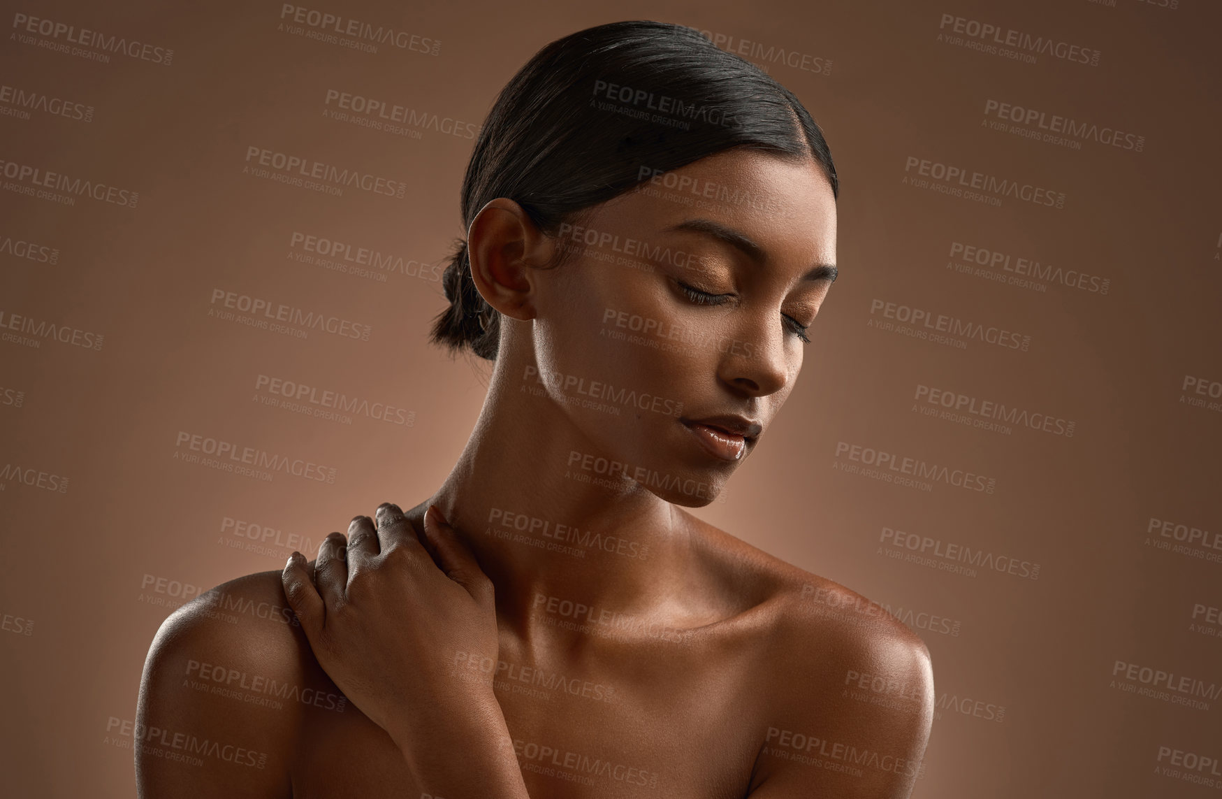 Buy stock photo Shot of a beautiful young woman posing against a brown background