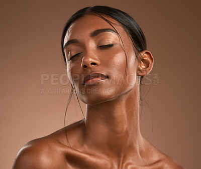 Buy stock photo Shot of a beautiful young woman posing against a brown background