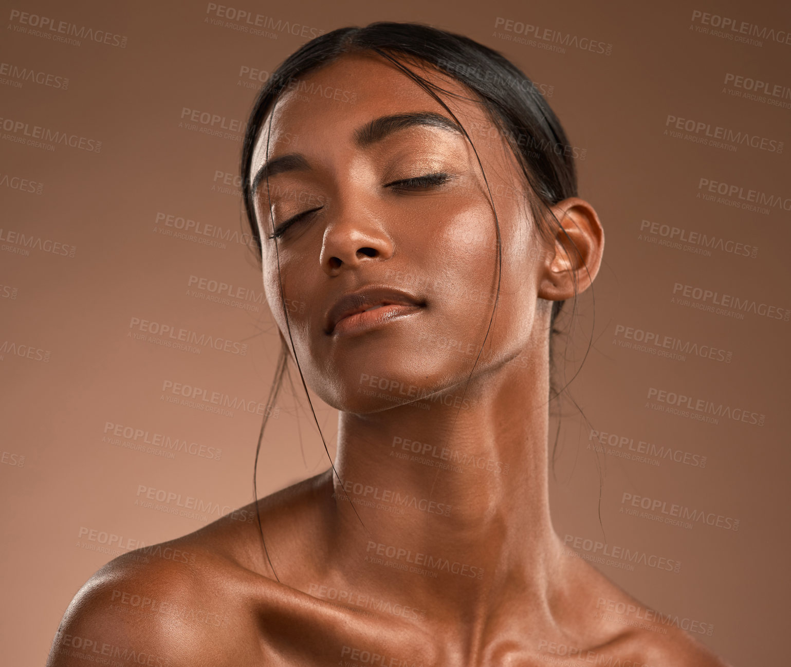 Buy stock photo Shot of a beautiful young woman posing against a brown background