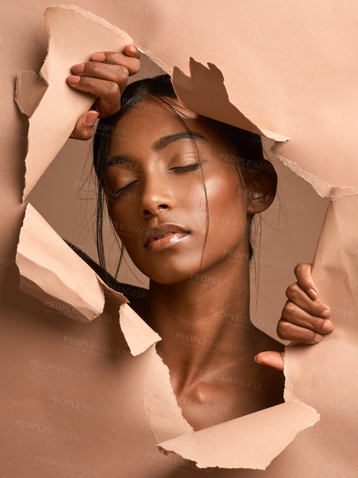 Buy stock photo Closeup shot of a young attractive woman tearing through brown paper