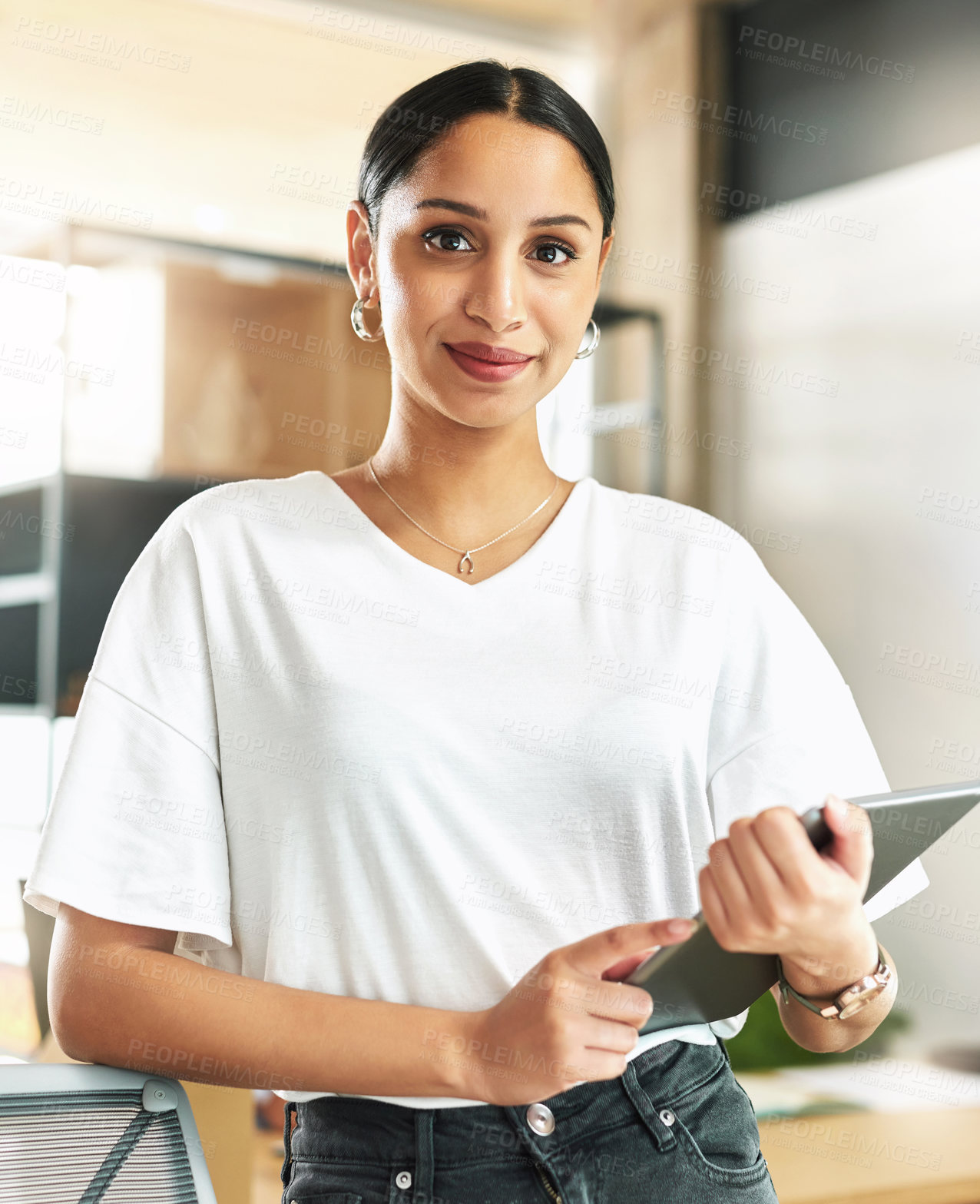 Buy stock photo Shop of a young businesswoman holding a digital tablet at work