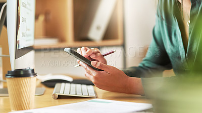 Buy stock photo Shot of a businesswoman using her smartphone at her desk