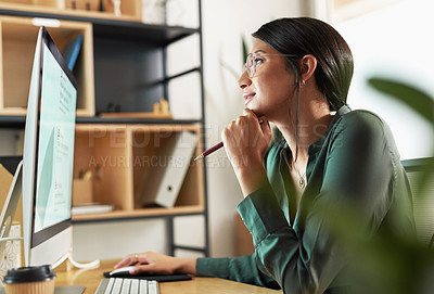 Buy stock photo Shot of a young businesswoman looking at her computer screen at work