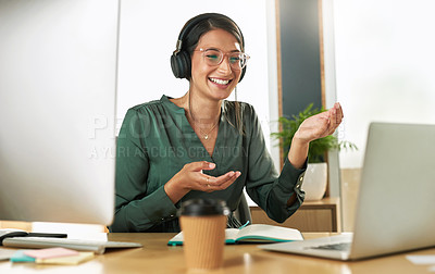 Buy stock photo Shot of a young businesswoman using her laptop to host a video conference at work