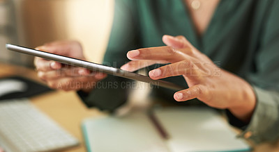 Buy stock photo Shot of a businesswoman using her digital tablet at her desk