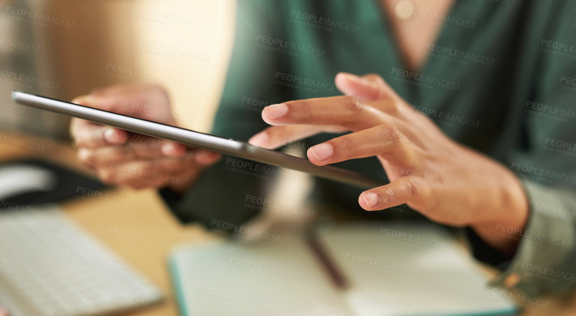 Buy stock photo Shot of a businesswoman using her digital tablet at her desk