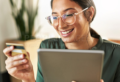Buy stock photo Shot of a young businesswoman using her digital tablet to shop online