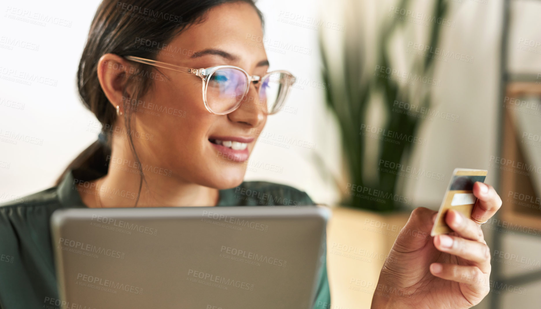 Buy stock photo Shot of a young businesswoman using her digital tablet to shop online