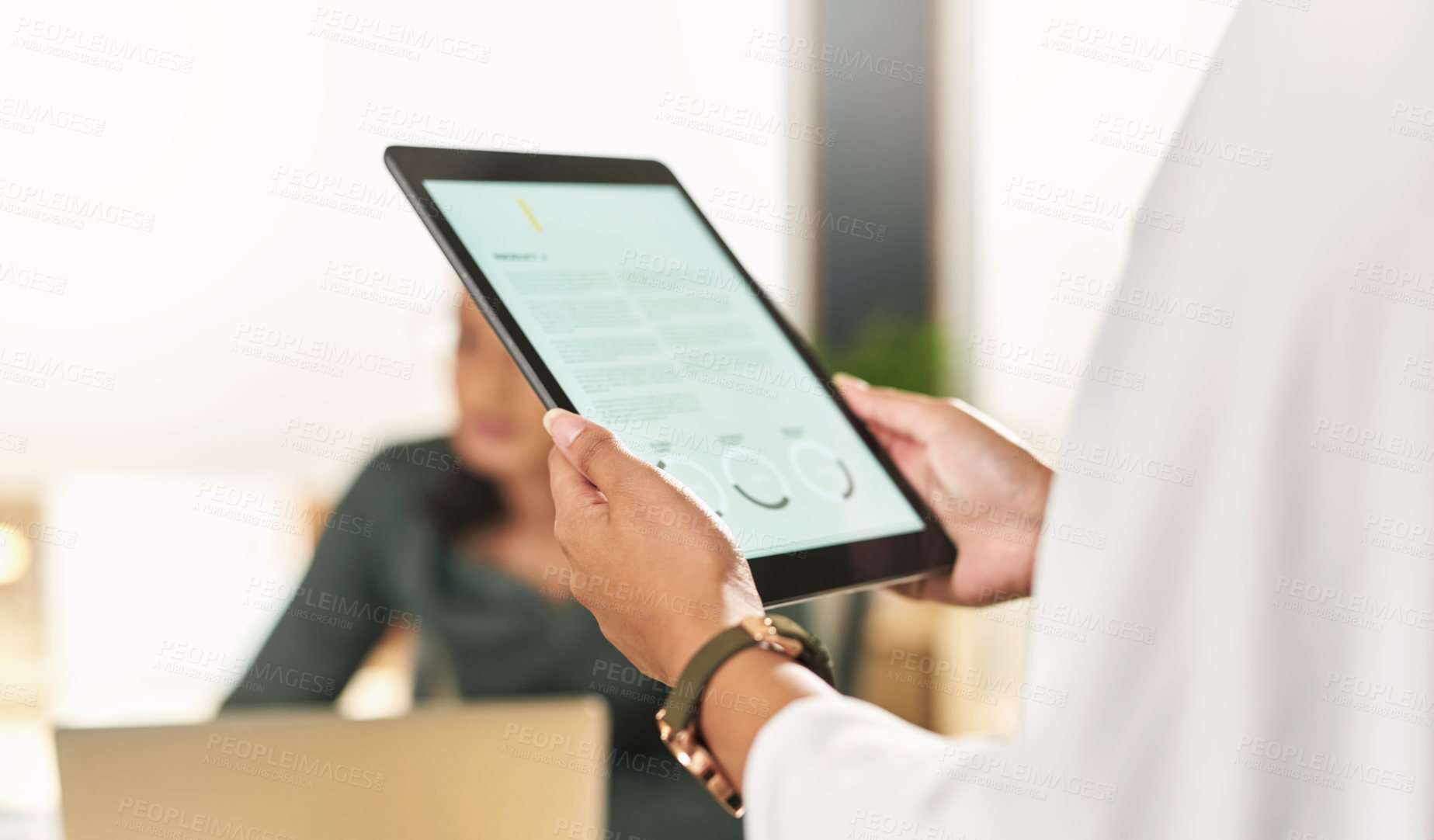 Buy stock photo Shot of a businesswoman using her digital tablet at her desk