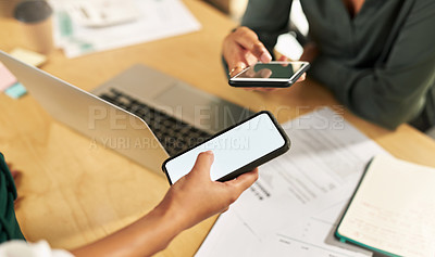 Buy stock photo Shot of a businesswoman using her smartphone at her desk