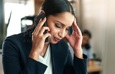 Buy stock photo Shot of a young businesswoman taking a call on her smartphone at work