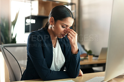 Buy stock photo Shot of a young businesswoman experiencing a headache at work