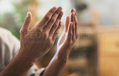 Buy stock photo Shot of a unrecognizable muslim man praying in the lounge at home