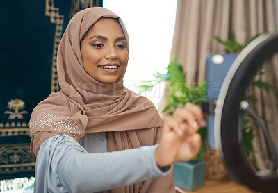 Buy stock photo Shot of a young muslim female busy recording her for her vlog
