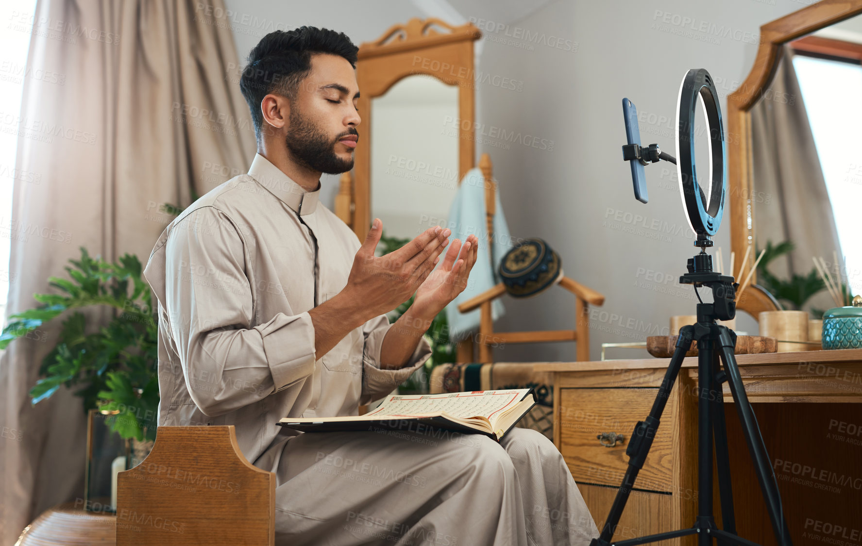 Buy stock photo Shot of a young muslim man busy recording his for her vlog