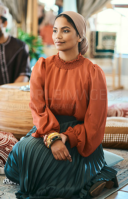 Buy stock photo Shot of a young muslim woman sitting down